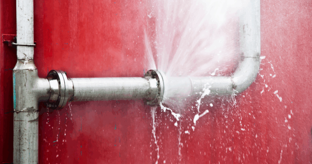 Burst pipe spraying water and licensed Las Vegas plumber from Fast Plumbing provides emergency leak detection and repair service.